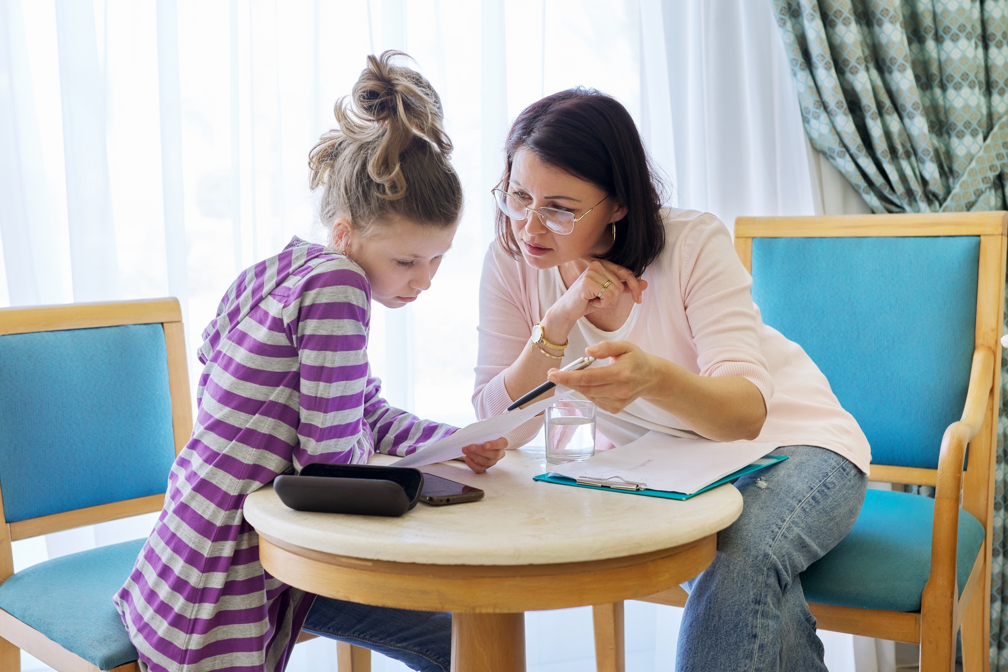 Pre-adolescent girl at consultation with social worker in office